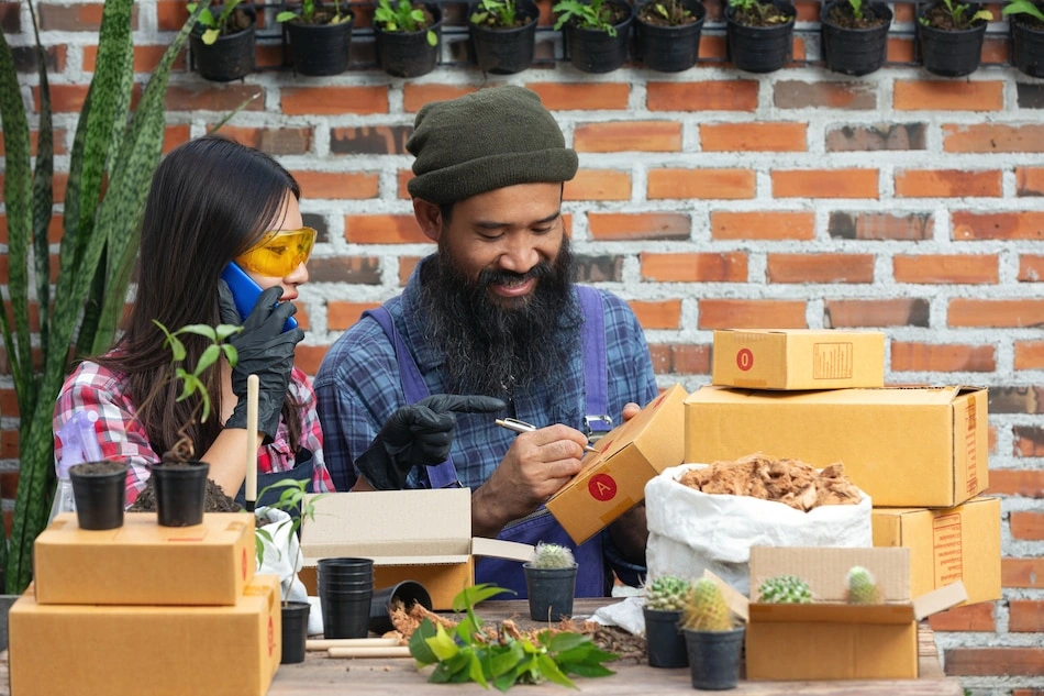 Local plant business owner communicating with customer by mobile phone